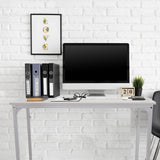 Hvidt skrivebord WORKSPACE I med mål på 100 × 50 cm foran en hvid murstensvæg fra hjh OFFICE