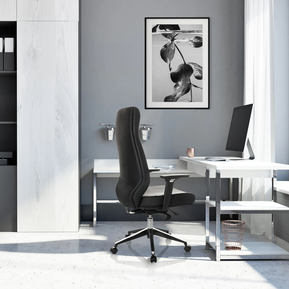 Profi-Chefsessel VITORO ECO in Schwarz mit hoher Rückenlehne und Fußkreuz vor einem weißen Schreibtisch von hjh OFFICE