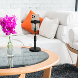 Sort holder til mobiltelefon & tablet FLEXMOBI II med smartphone på et glasbord foran en hvid sofa fra hjh OFFICE